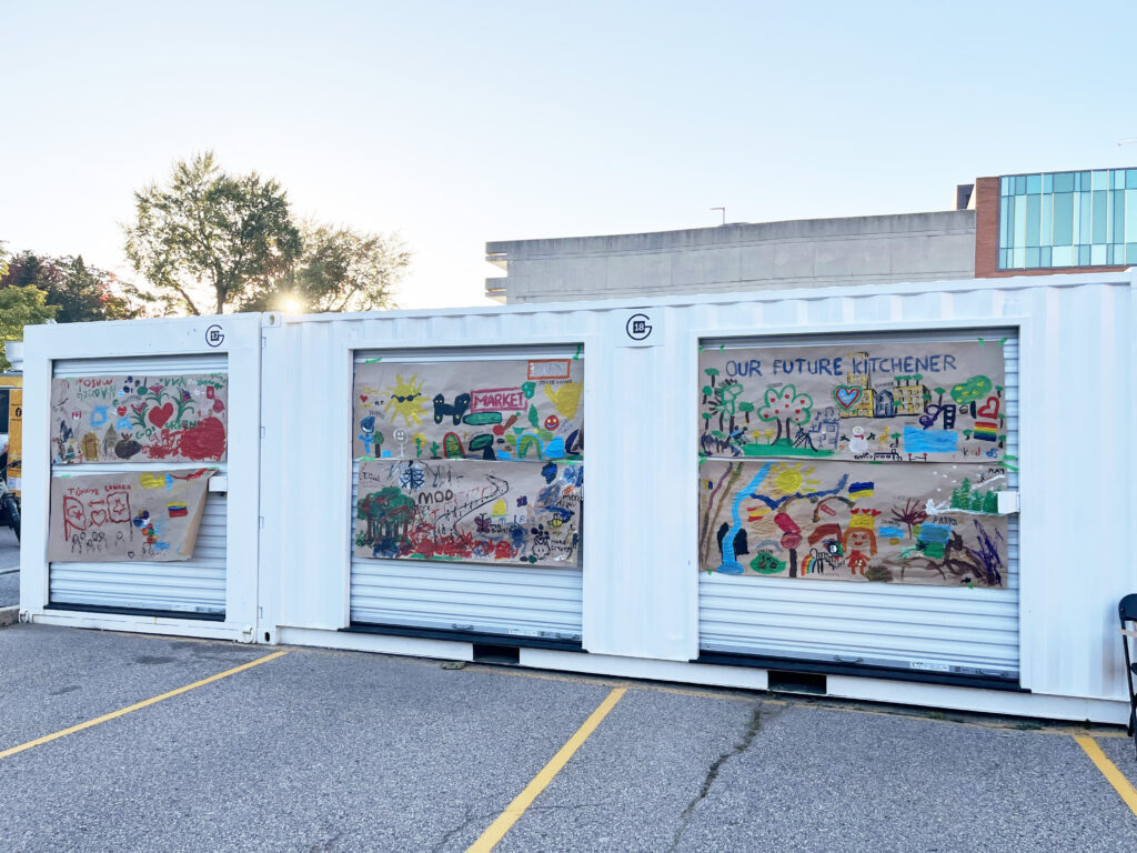 6 large pieces of craft paper showcasing various paintings done by participants for the Thriving City Mural at the Block Party engagement event.